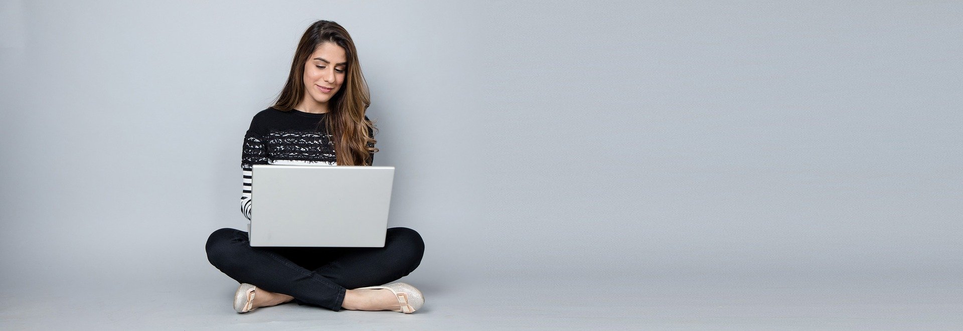 Dental professional searching job postings on a laptop