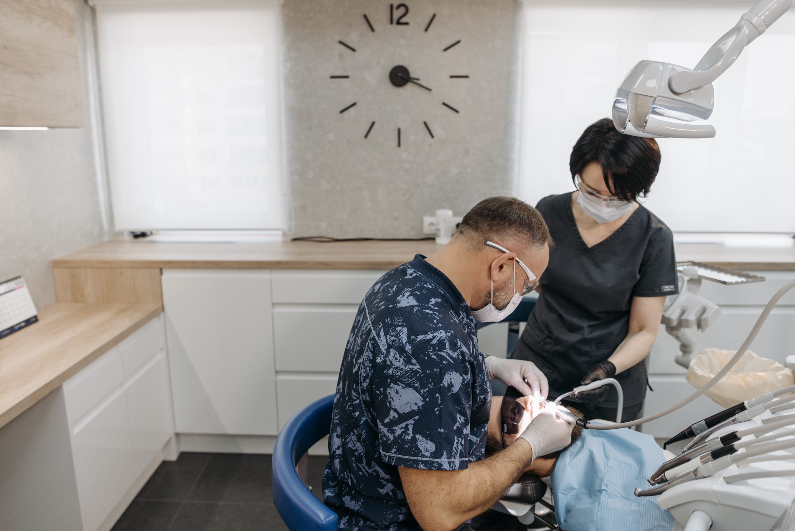 Dentist and dental assistant treating a patient