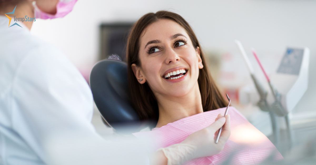 Smiling patient in a dental chair during a hygiene appointment